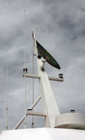 boat resting inside the harbor at low tideの写真素材