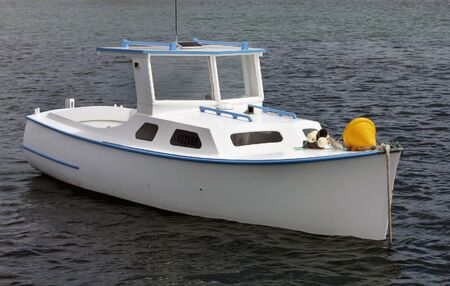 boat resting inside the harbor at low tideの写真素材