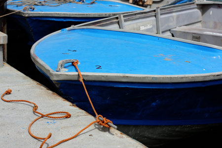 boat resting inside the harbor at low tideの写真素材