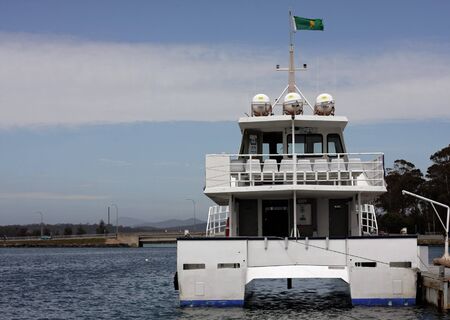 boat resting inside the harbor at low tideの写真素材