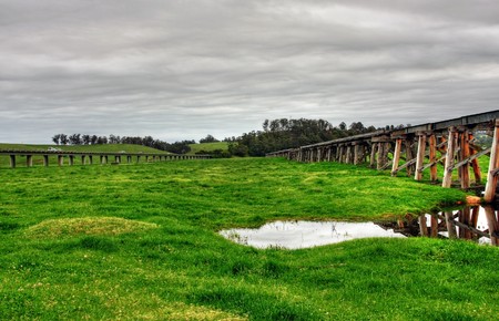 Old Railway Bridge against green landscapeの写真素材