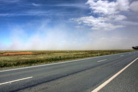 dust storm over an australian roadの写真素材
