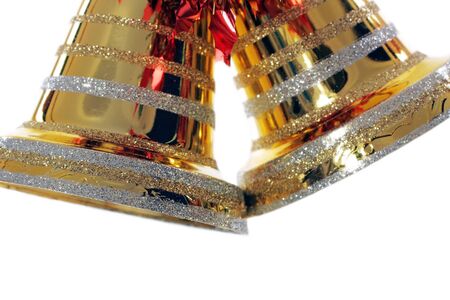 golden christmas bell against white backgroundの写真素材