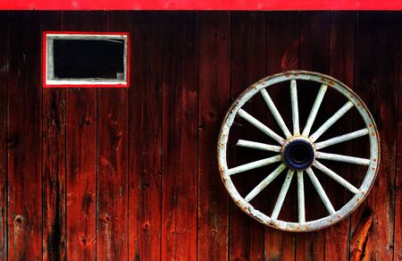 rustic wagon wheel hanging on a wallの写真素材