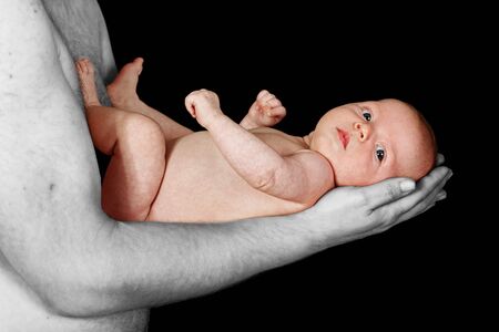 loving father holding infant daughter tenderlyの写真素材