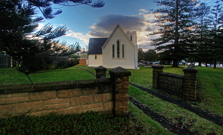 quiet white church against green and blueの写真素材