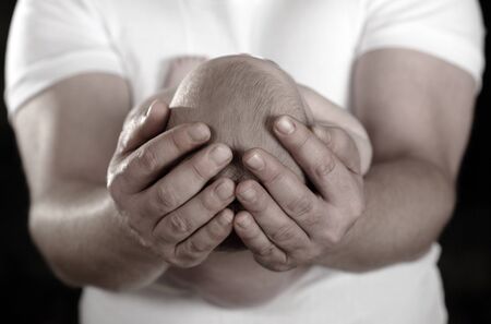 loving father holding infant daughter tenderlyの写真素材