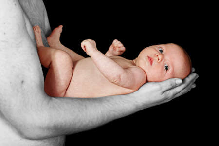 loving father holding infant daughter tenderlyの写真素材