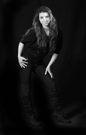 attractive young girl against blackの写真素材