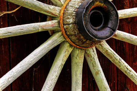 rustic wagon wheel hanging on a wallの写真素材