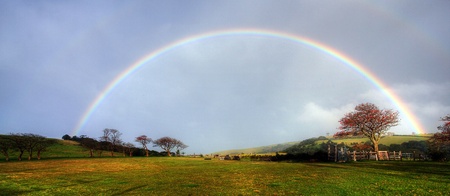 rainbow over a farm fieldの写真素材