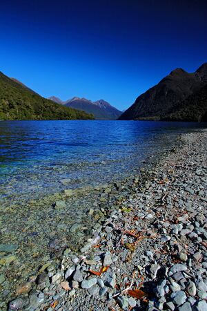 mirror lakes against blue skyの写真素材