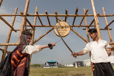 Unidentified people perform a medieval fight show with swords in retro costume of ancient Turkish troops and ottoman empire soldier.ISTANBUL,TURKEY,MAY 13,2017のeditorial素材
