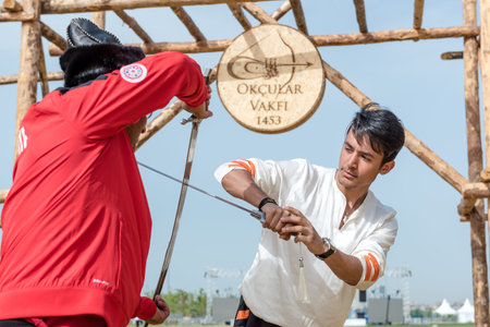 Unidentified people perform a medieval fight show with swords in retro costume of ancient Turkish troops and ottoman empire soldier.ISTANBUL,TURKEY,MAY 13,2017のeditorial素材