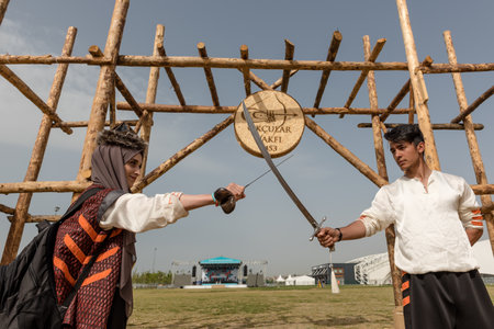 Unidentified people perform a medieval fight show with swords in retro costume of ancient Turkish troops and ottoman empire soldier.ISTANBUL,TURKEY,MAY 13,2017のeditorial素材