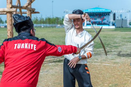 Unidentified people perform a medieval fight show with swords in retro costume of ancient Turkish troops and ottoman empire soldier.ISTANBUL,TURKEY,MAY 13,2017のeditorial素材