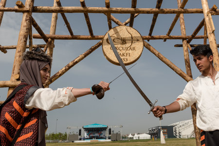 Unidentified people perform a medieval fight show with swords in retro costume of ancient Turkish troops and ottoman empire soldier.ISTANBUL,TURKEY,MAY 13,2017のeditorial素材