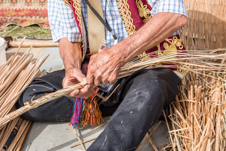 Unidentified man makes a traditional wicker basket.の写真素材