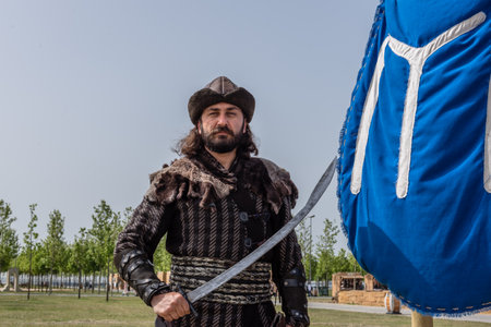 Unidentified man with a sword in costume of ancient Turkish troops of ottoman empire soldiers.ISTANBUL,TURKEY,MAY 13,2017のeditorial素材