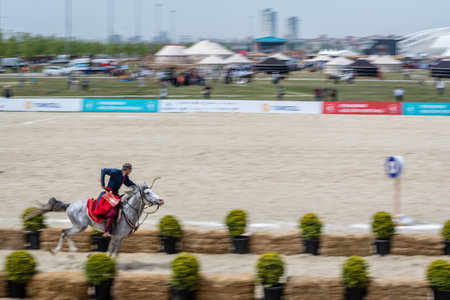 Unidentified man in costumes of ancient Ottoman Empire archer soldiers shoots at an archery competition while riding a horse.ISTANBUL,TURKEY,May 13,2017のeditorial素材