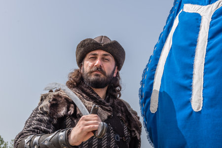 Unidentified man with a sword in costume of ancient Turkish troops of ottoman empire soldiers.ISTANBUL,TURKEY,MAY 13,2017のeditorial素材