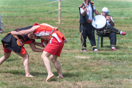 Unidentified people perform aba guresi (kuroshio/wrestlers)at a public event.Aba wrestling is a traditional Turkish wrestling also called Asirtmali Aba Wrestling. ISTANBUL,TURKEY,May 13,2017のeditorial素材