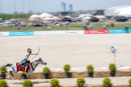 Unidentified man in costumes of ancient Ottoman Empire archer soldiers shoots at an archery competition while riding a horse.ISTANBUL,TURKEY,May 13,2017のeditorial素材