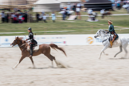 Unidentified people in costumes of ancient Ottoman Empire archer soldier are at an archery competition while riding a horse.ISTANBUL,TURKEY,May 13,2017のeditorial素材