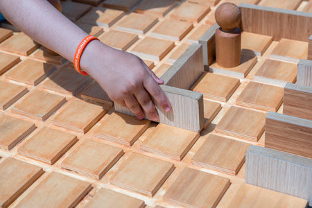 Unidentified children play a traditional Turkish wooden puzzle game. Etnospor culture festival is written on bracelet.ISTANBUL, TURKEY,MAY 13,2017のeditorial素材