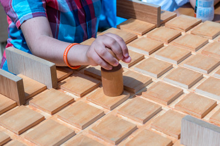 Unidentified children play a traditional Turkish wooden puzzle game. Etnospor culture festival is written on bracelet.ISTANBUL, TURKEY,MAY 13,2017のeditorial素材