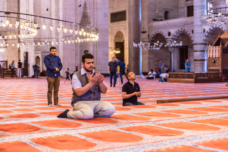 ISTANBUL,TURKEY - June 6,2017:Turkish muslim men praying in  suleymaniye mosque in Istanbul,Turkey.Suleymaniye mosque,. Tourists and local people visit this historical landmark every season.のeditorial素材