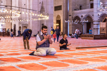 ISTANBUL,TURKEY - June 6,2017:Turkish muslim men praying in  suleymaniye mosque in Istanbul,Turkey.Suleymaniye mosque,. Tourists and local people visit this historical landmark every season.のeditorial素材