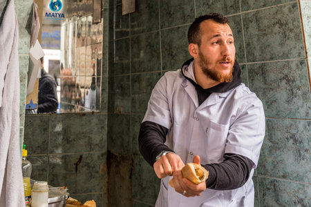 Turkish style chopped mussels (Midye tava) fried in deep oil  in a special pan on the Street in Istanbul, Turkey.のeditorial素材