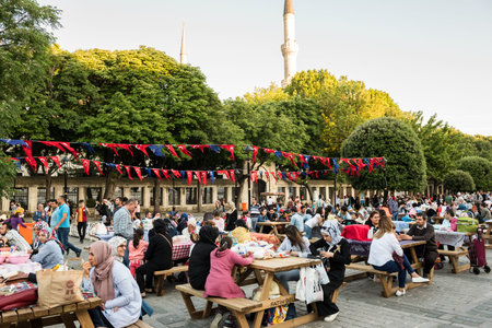 Muslim people who are fasting wait for the adhan (ezan) and evening meal (Iftar) in Ramadan month in...