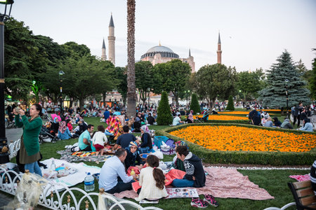 Muslim people who are fasting wait for the adhan (ezan) and evening meal (Iftar) in Ramadan month in Sultan Ahmet Park, Istanbul,Turkey.ISTANBUL,TURKEY,JUNE 11,2017のeditorial素材