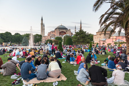 Muslim people who are fasting wait for the adhan (ezan) and evening meal (Iftar) in Ramadan month in Sultan Ahmet Park, Istanbul,Turkey.ISTANBUL,TURKEY,JUNE 11,2017のeditorial素材