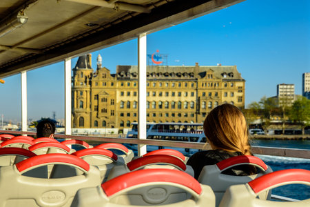 Traditional public ferry passes by historical train terminal named Haydarpasa. Until 2012 the station was a major intercity, regional and commuter rail hub in Turkey.ISTANBUL,TURKEY,APRIL 20,2017のeditorial素材