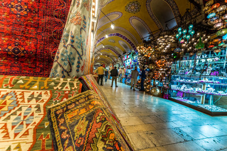 Unidentified people visiting the Grand Bazaar for shopping,Turkish rug and carpet on the front...