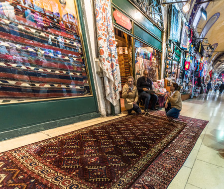 Unidentified Tourists shopping rugs and carpets in the Grand Bazaar in Istanbul. Interior view of the Grand Bazaar.Istanbul, Turkey.April 17, 2017のeditorial素材