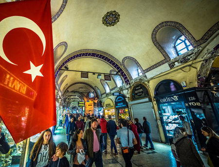 Unidentified Tourists visiting and shopping in the Grand Bazaar in Istanbul. Interior of the Grand Bazaar with Turkish Flag on the foreground.Istanbul, Turkey.April 17, 2017

のeditorial素材