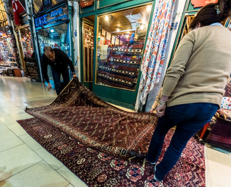 Unidentified Tourists shopping rugs and carpets in the Grand Bazaar in Istanbul. Interior view of the Grand Bazaar.Istanbul, Turkey.April 17, 2017のeditorial素材