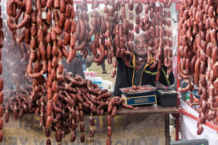Unidentified man selling salami made of camel meat in Selcuk camel wrestling arena.Izmir,Turkey.January 16, 2017のeditorial素材