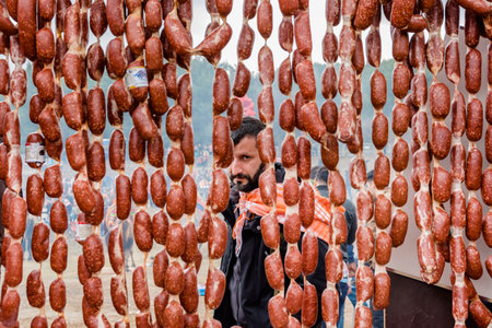 Unidentified man selling salami made of camel meat in Selcuk camel wrestling arena.Izmir,Turkey.January 16, 2017のeditorial素材