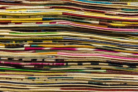 Traditional colorful silk ,cashmere head scarves or shawls and fabrics composed of a stack background at the bazaar stall in Istanbul, Turkeyの写真素材