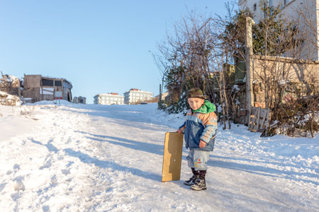 Children slide on snow in old school style with hardwood sled in Istanbul.Happiness and joy concept.Istanbul,Turkey.01,January,2016のeditorial素材