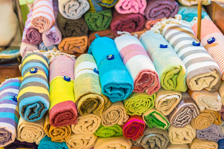 Composed Roll shaped stacked Traditional colorful silk ,cashmere head scarves or shawls and fabrics for sale in Grand Bazaar,Istanbul,Turkeyの写真素材