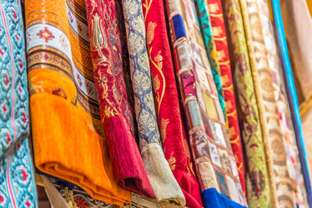 Traditional colorful silk ,cashmere head scarves or shawls and fabrics composed of a stack...