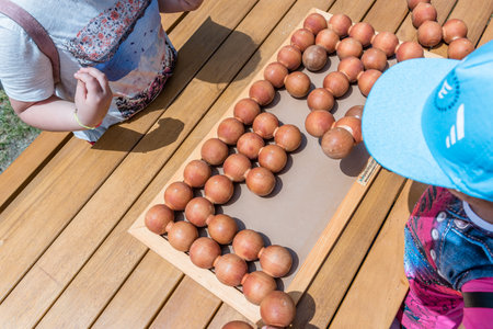 Unidentified children play a traditional Turkish wooden puzzle game. Etnospor culture festival is written on bracelet.ISTANBUL, TURKEY,MAY 13,2017のeditorial素材
