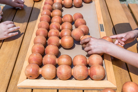 Unidentified children play a traditional Turkish wooden puzzle game. Etnospor culture festival is written on bracelet.ISTANBUL, TURKEY,MAY 13,2017のeditorial素材