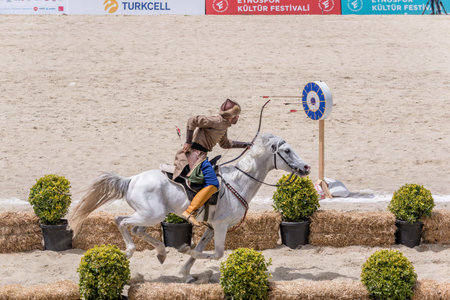 Unidentified people in costumes of ancient Ottoman Empire archer soldiers shoots at archery competition while riding horse.ISTANBUL,TURKEY,May 13,2017のeditorial素材